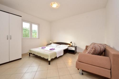 a bedroom with a bed and a couch at Holiday home in Drage with sea views, balcony, air conditioning,WiFi 592-1 in Drage