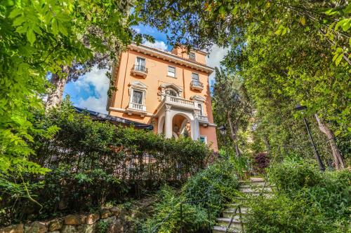 a house with stairs leading up to it at Mangili Garden Hotel in Rome
