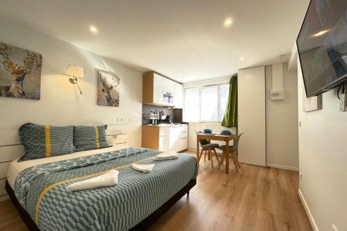 a small bedroom with a bed and a kitchen at M4 Coeur Massy RER BC 600m - Orly20 min in Massy