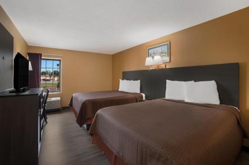 a hotel room with two beds and a flat screen tv at Econo Lodge in Allentown