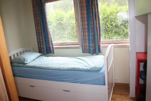 a small bed in a room with a window at 14 B in Stavanger