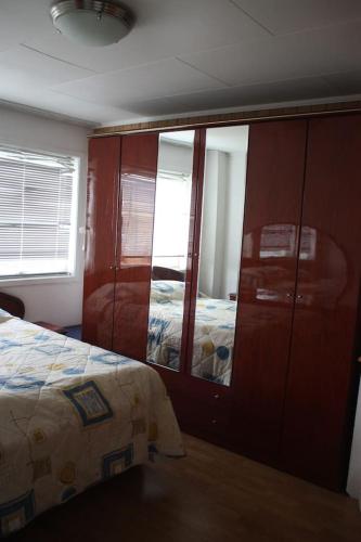 a bedroom with a bed and a dresser with a mirror at 14 B in Stavanger