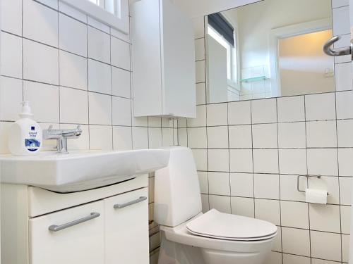 a bathroom with a toilet and a sink and a mirror at Studio Apartment In Herlev, Herlevgrdsvej 4, in Herlev