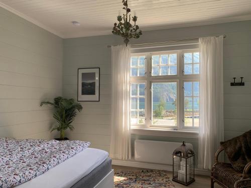 a bedroom with a bed and a window at Valldal Sentrum Overnatting in Valldal