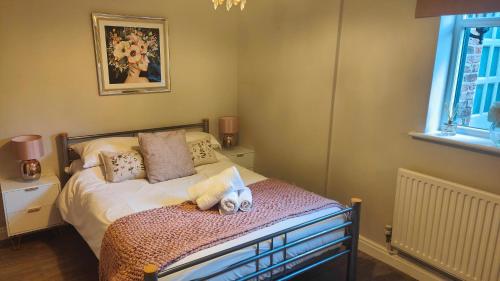 a bedroom with a bed with two stuffed animals on it at Chester City Apartments - With free parking in Chester