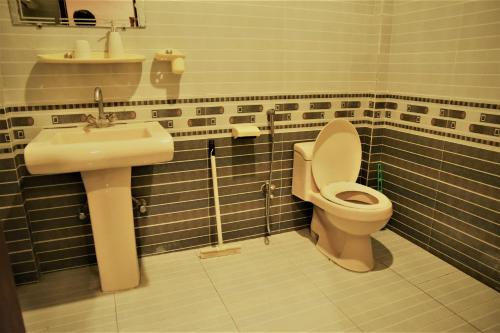a bathroom with a toilet and a sink at Republika by Summit Resorts in Abbottabad