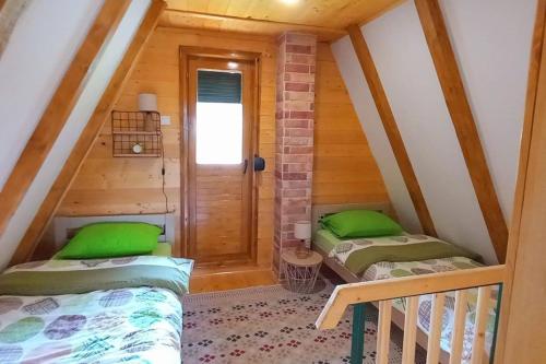 a room with two beds in a attic at Durmitor Chill Chalet in Žabljak
