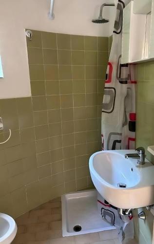 a bathroom with a toilet and a sink at GG Apartment Salò in Salò