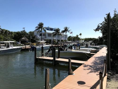 a group of boats docked at a marina at Tropical Getaway w/Private Beach 1 BD Condo in Tavernier