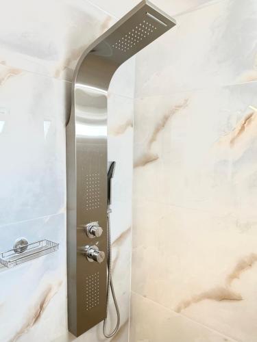 a shower in a bathroom with a shower head at Step One | Luxury Suites right in the heart of Acropolis next to metro station in Athens