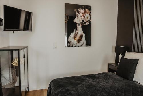 a bedroom with a bed and a picture on the wall at Boutique Hotel Cologne in Cologne