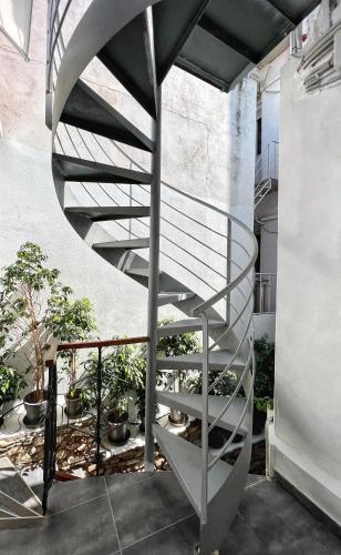 a spiral staircase in a building with plants at Step One | Luxury Suites right in the heart of Acropolis next to metro station in Athens