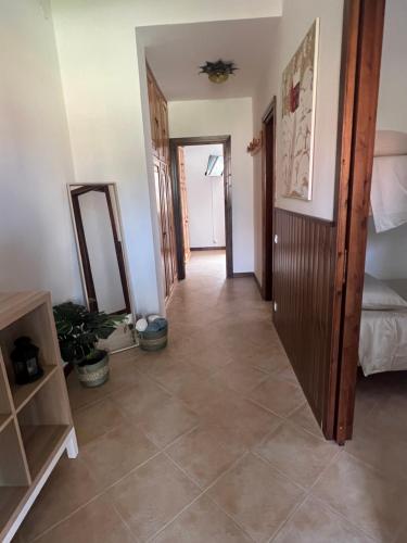 a hallway with a room with a mirror and a bed at Casa Vacanza Regina in Roccaraso