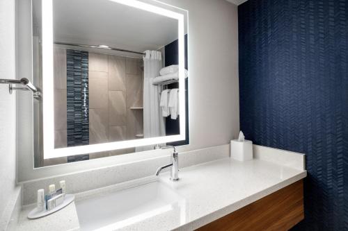 a bathroom with a sink and a mirror at Fairfield Inn & Suites Boulder in Boulder