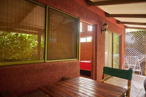 a room with a wooden table and a window at Cabañas Maria Hau in Hanga Roa