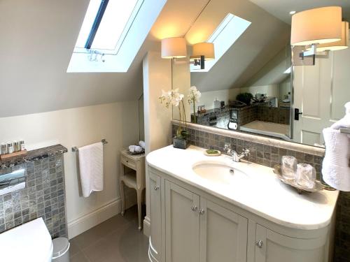 a bathroom with a sink and a mirror at The Gatehouse - UK36939 in Lamerton