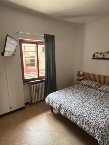 1 dormitorio con cama y ventana en Casa Vacanza Regina, en Roccaraso