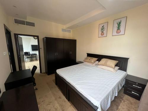 a bedroom with a large bed with white sheets at Limra complex in Abu Dhabi