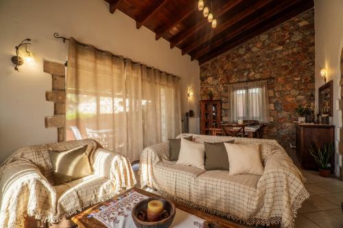 a living room with a couch and a chair at Agnadia Villa in Stalos
