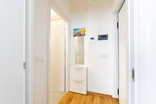 a hallway with white walls and a white door at ~ Cozy Apartment ~ City Center [Train Station] in Trieste