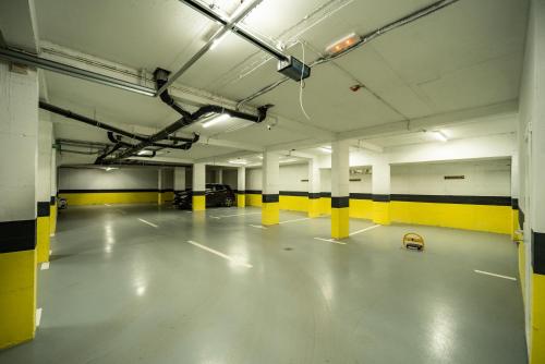 an empty parking garage with yellow and white columns at MODERN MOUNTAIN II in Kolašin