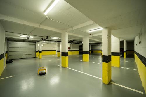 an empty parking garage with yellow and black pillars at MODERN MOUNTAIN II in Kolašin