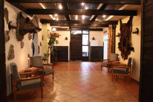 a hallway with chairs and tables in a room at Hotel Bucegi Portile Regatului in Paraul Rece