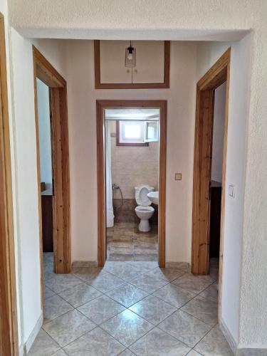 a hallway of a bathroom with a toilet in it at Xristos Villa in Nea Vrasna