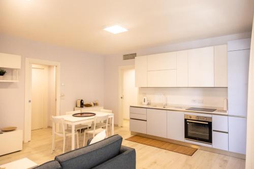 a kitchen with a couch and a table in a room at Novatek Apartment 202 Exclusive in Pescara