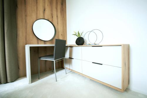 a dressing table with a chair and a mirror at Apartmány 316 a 317 Vila Zuberec in Zuberec