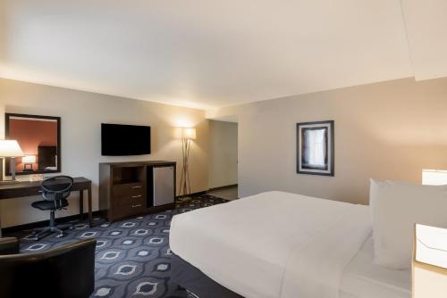 a hotel room with a large bed and a desk at Grand Z Hotel Casino by Red Lion Hotels in Central City