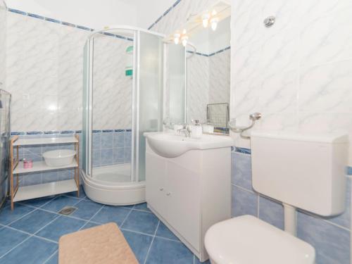 a bathroom with a shower and a sink and a toilet at Apartments Pavla&Niko in Lokva Rogoznica