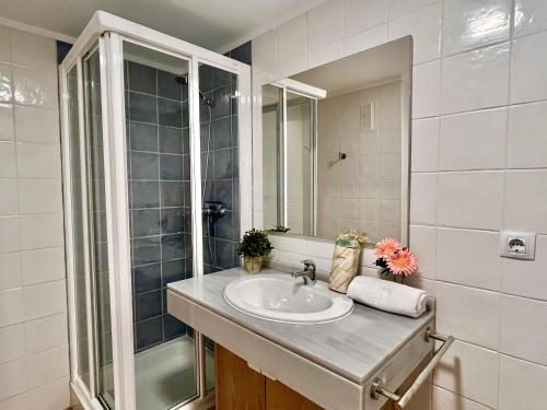 a bathroom with a sink and a shower at Mar y Montana House by Gloove in Altea la Vieja