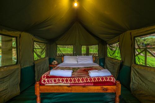 a bed in the middle of a tent at Bunyonyi Overland Resort in Kabale