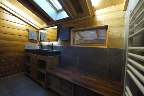 a bathroom with a sink and a mirror at Chalet La Trouvaille in Thollon