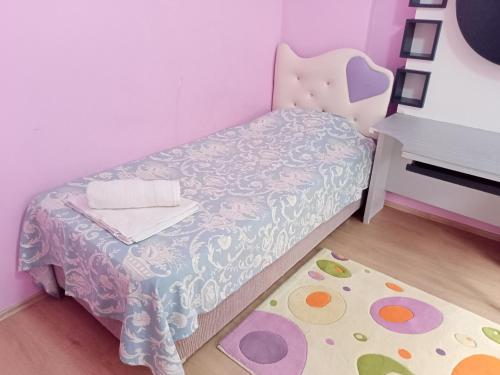 a small bedroom with a bed and a desk at Sky Ankara Big Suit Home in Ankara
