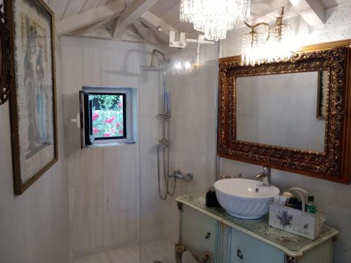 a bathroom with a sink and a mirror at Penelope suite 