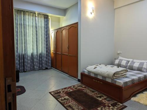 a bedroom with a bed and a large window at Success Apartments - Silver in Mwanza