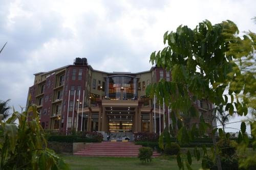 a large building with stairs in front of it at Las Vegas Garden Hotel Mbarara in Mbarara