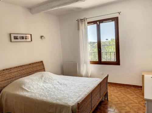 a bedroom with a bed and a window at Villa sainte maxime golfe de Saint Tropez in Sainte-Maxime