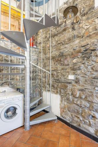 a washing machine in a room with a stone wall at ALBERTA Rooms Manarola in Manarola