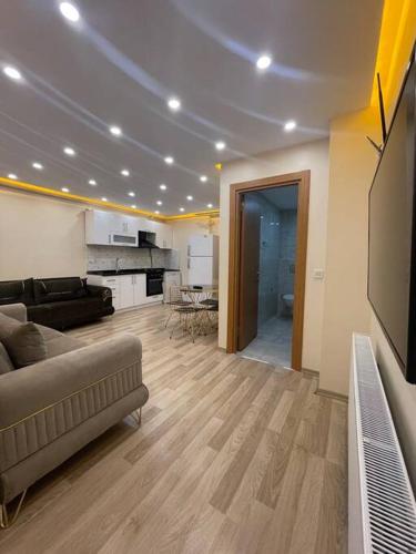 a living room with a couch and a tv at شقه حديثه بمساحه كبيره 13 in Istanbul