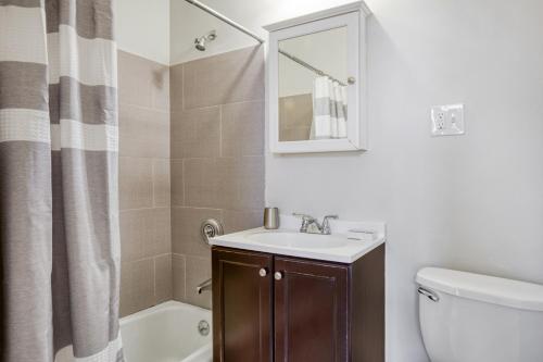 a bathroom with a sink and a toilet and a mirror at Well-located S Boston 1BR on E Broadway BOS-473 in Boston