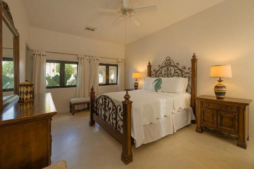 a bedroom with a large bed with white sheets and a fan at The Queen of Cozumel Beach House -Luxury Beachfront Villa- MILLION DOLLARS VIEW in Cozumel