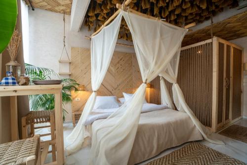 a bedroom with a bed with a mosquito net at Biophilia Luxury Lofts in Beirut