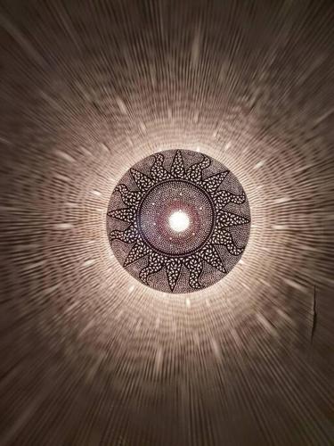 a ceiling light with a circular design on it at Mirador del Olivar in Olvera