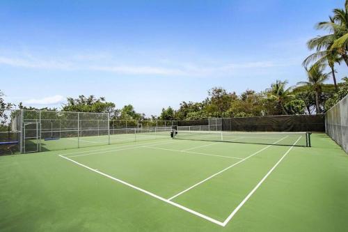 a tennis court with two tennis rackets on it at Beautiful 2/2 condo in Kailua Kona. Ocean View! in Kailua-Kona