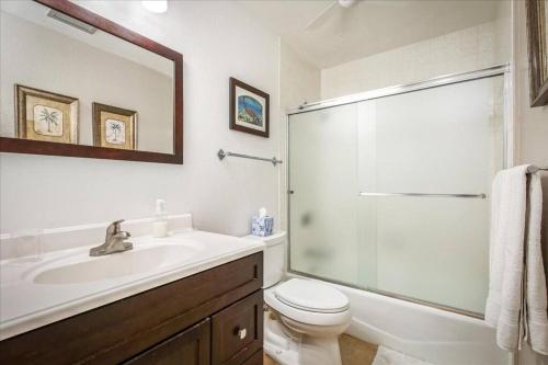 a bathroom with a sink and a toilet and a shower at Beautiful 2/2 condo in Kailua Kona. Ocean View! in Kailua-Kona
