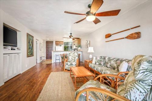 a living room with a couch and a ceiling fan at Beautiful 2/2 condo in Kailua Kona. Ocean View! in Kailua-Kona