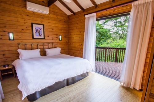 a bedroom with a bed and a large window at Imvubu Lodge in Richards Bay